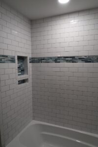 White Subway Tile and Mosaic Accent in Niche